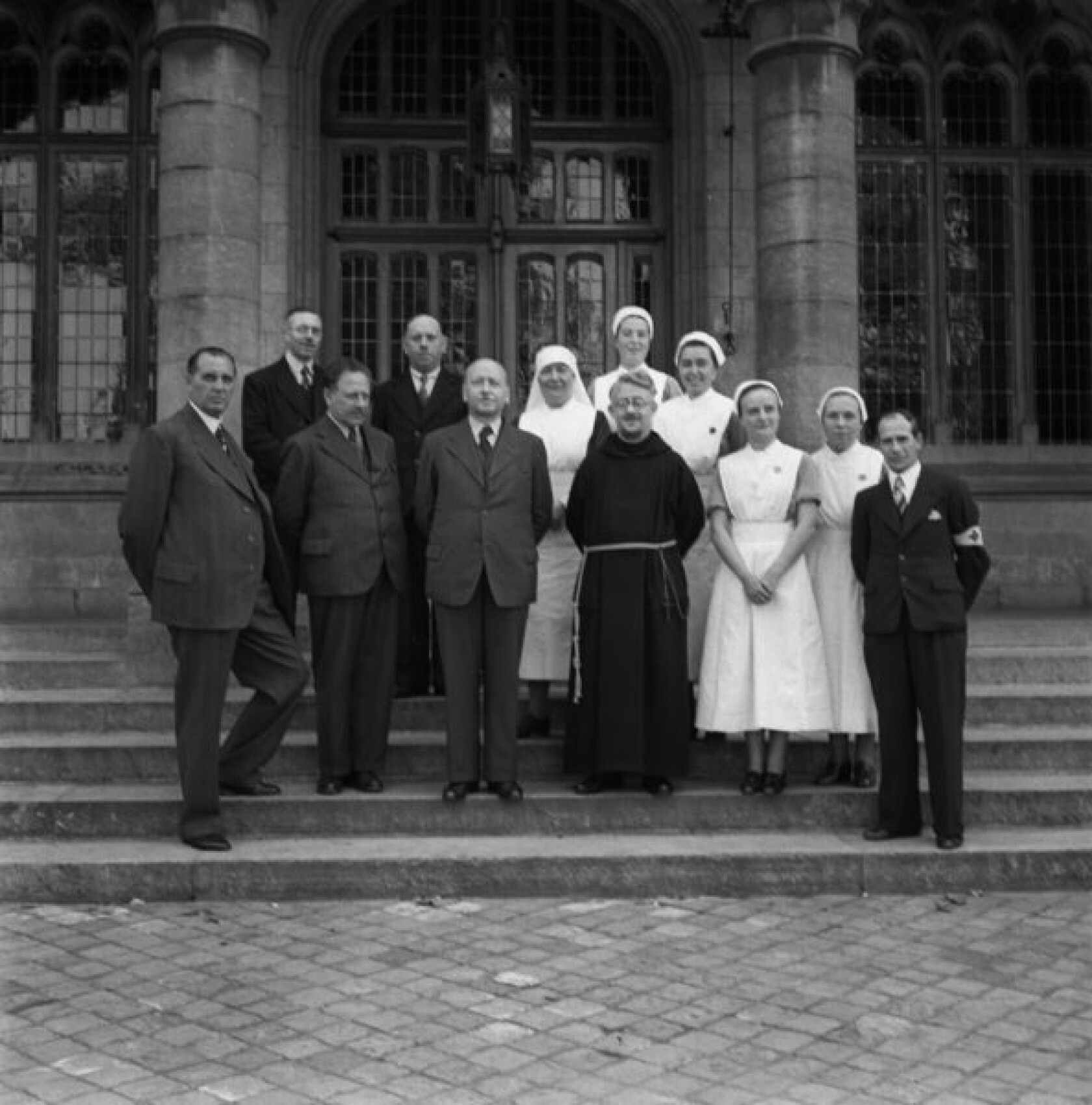 Groepsportret bij de ingang van de Minnewaterkliniek in de Gasthuisstraat 31 07 1940 p 593x600